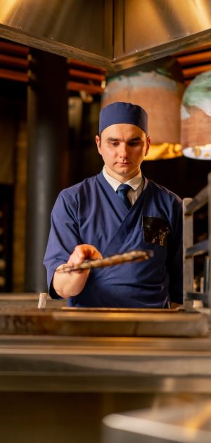 in-a-japanese-restaurant-chef-in-a-blue-uniform-fr-2024-05-02-20-55-10-utc
